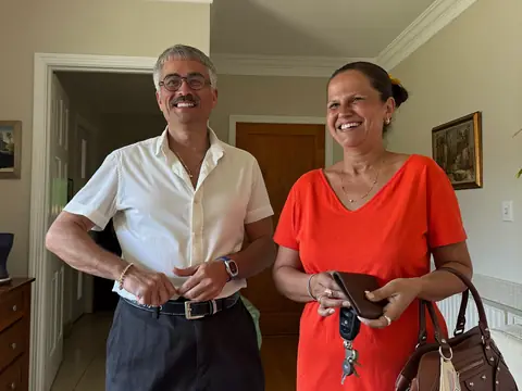 Pareja guardando la cartera antes de salir de casa